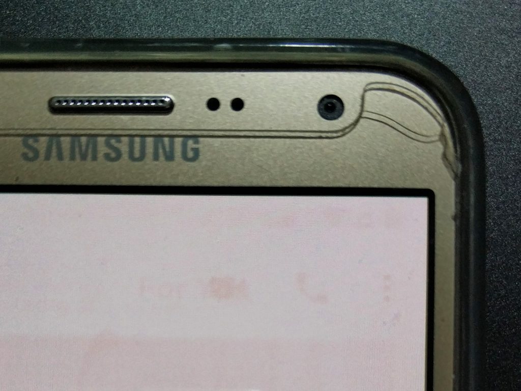 The WhatsApp video call, voice call, and menu buttons burnt into the AMOLED screen of a Samsung Galaxy J7 Prime